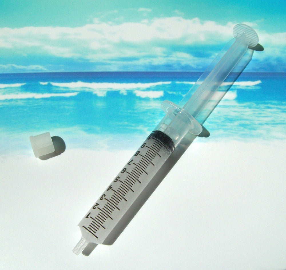 Four whitening gel syringes arranged in a pack