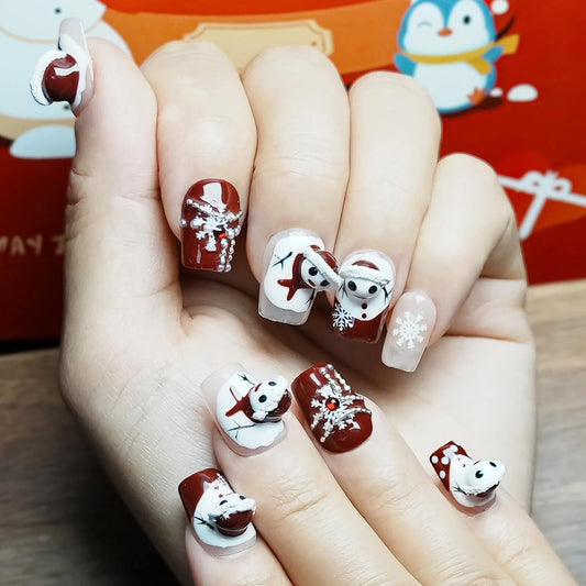 Tesytto nails feature snowflake rhinestones for sparkling winter accents.
