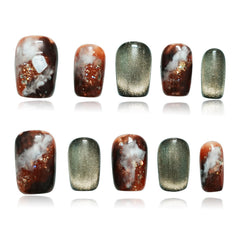 Tesytto Dark Green Cat Eye nails in coffin shape with amber glitter for eye-catching manicure