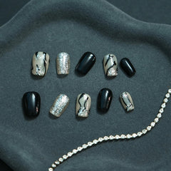 Tesytto marble press-on nails with silver glitter for festive sparkle.