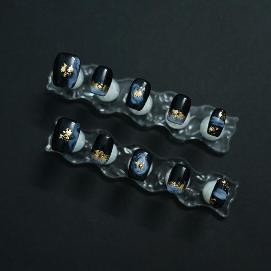 Tesytto nails with gold foil accents and hand-painted detail for standout style