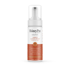 The Honey Pot Amber Sandalwood bottle closeup highlighting gentle plant-based feminine wash for sensitive skin.
