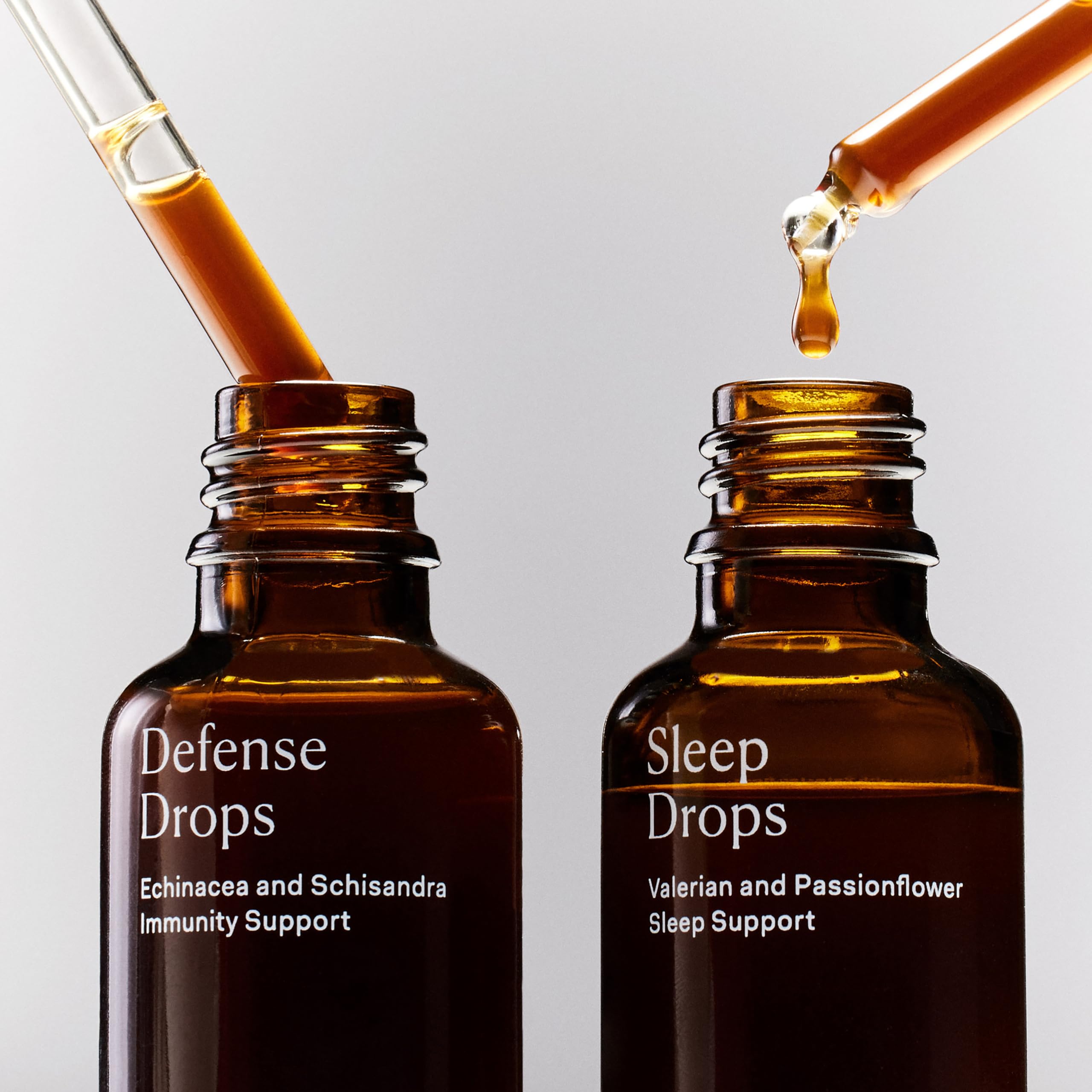 Sleep Drops bottle beside a glass of water
