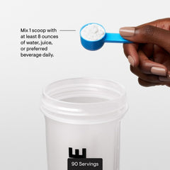L-Glutamine powder with measuring scoop and glass of water