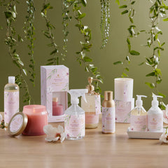 Person spraying Magnolia Willow mist in a living room