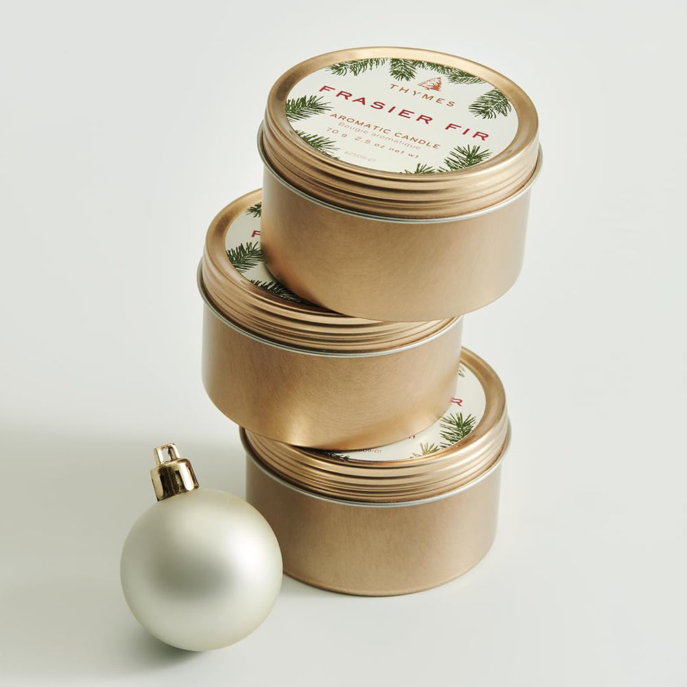 Gift-ready Thymes travel tin holiday candle packaging.