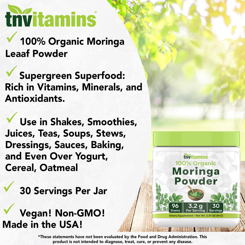 Moringa powder sprinkled from a scoop on a wooden surface