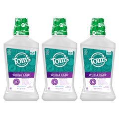 Clear bottle of Fresh Mint mouthwash with mint leaves in background