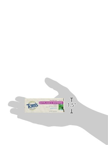 Travel-size 1 oz toothpaste tube next to mint leaves