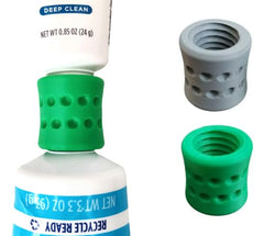 Two toothpaste refill adapters for Crest and Colgate in travel packaging