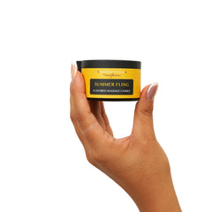 Candle lit to release tropical massage oil aroma