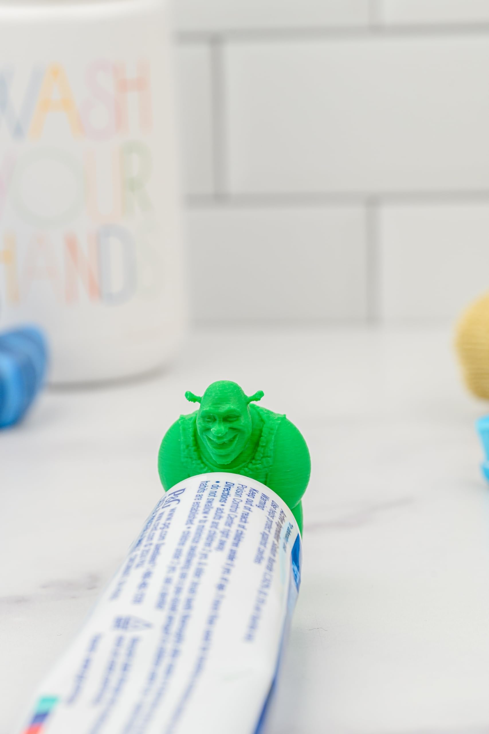 Shrek toothpaste topper on a toothpaste tube with smile