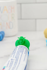Shrek toothpaste topper on a toothpaste tube with smile