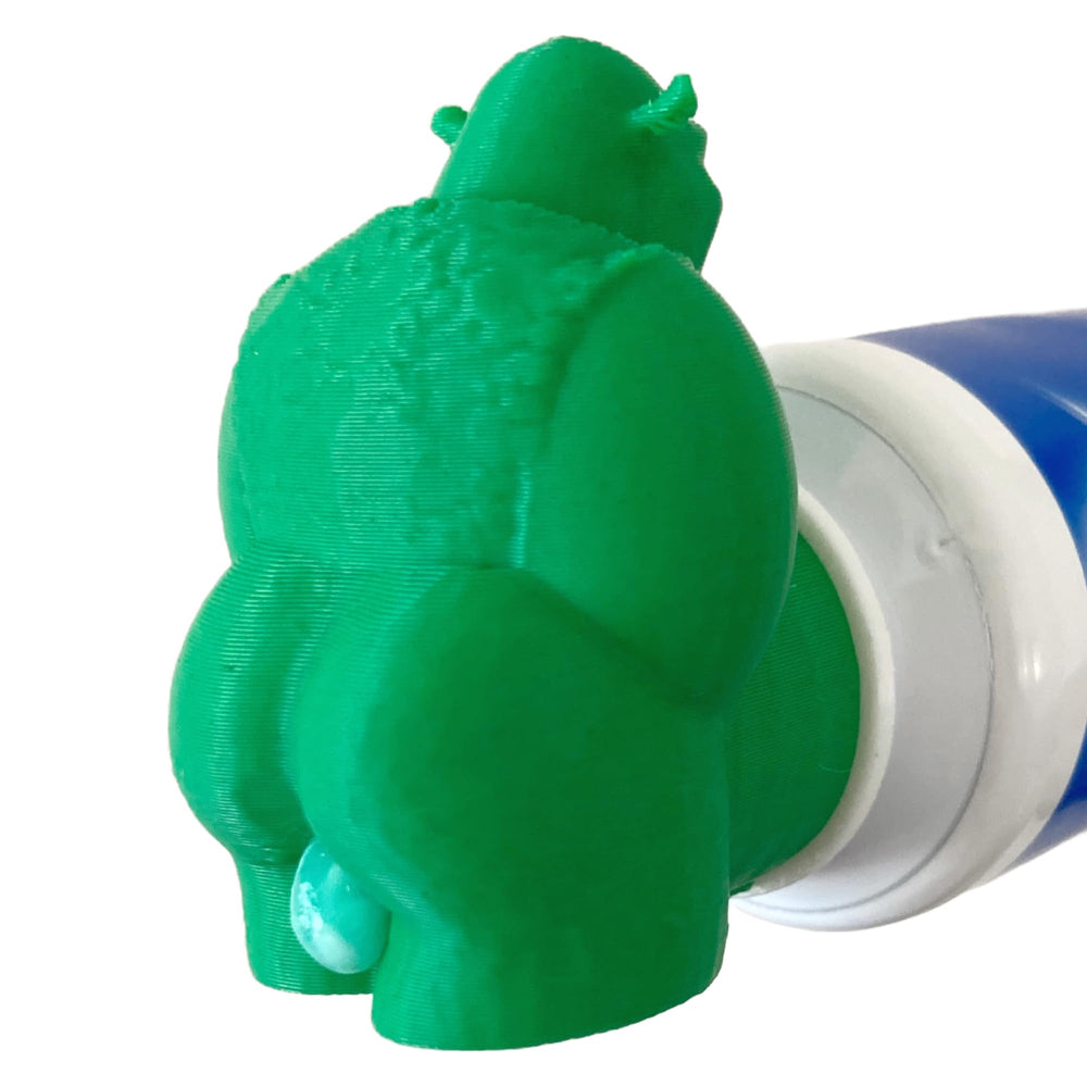 Fun gag gift concept: Shrek poop toothpaste topper on a tube
