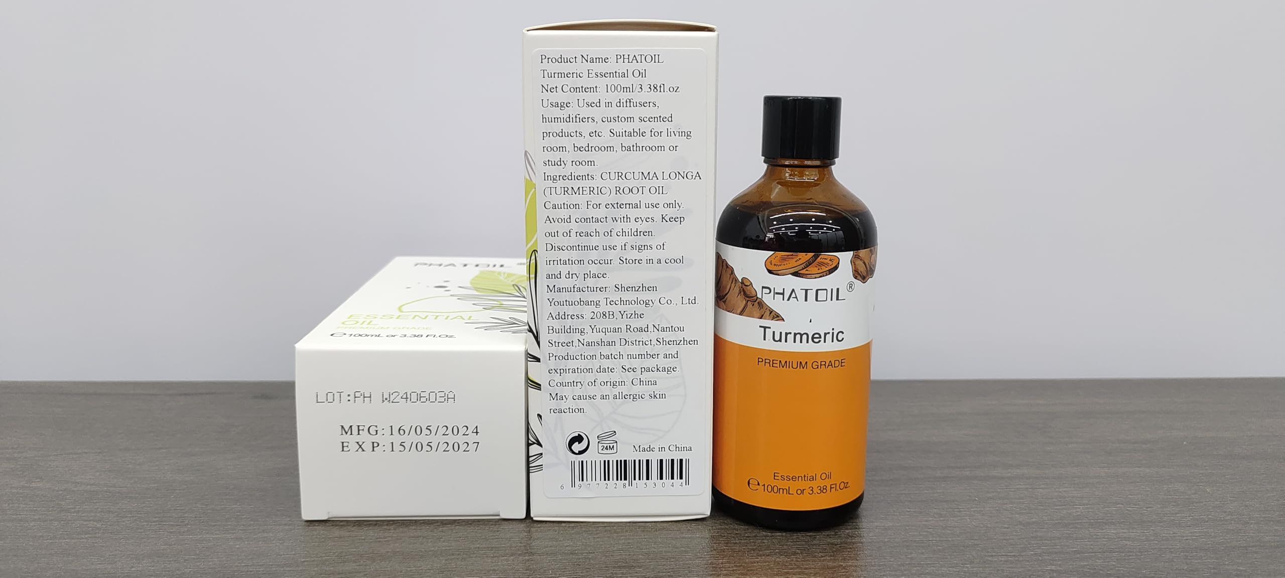 Close-up of turmeric essential oil in amber bottle