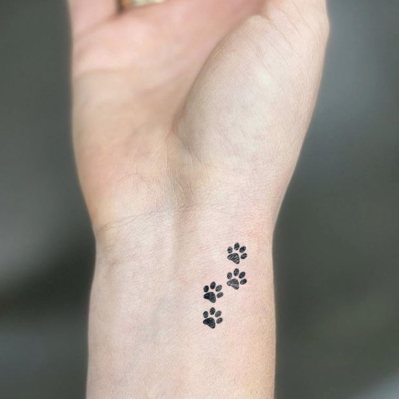 UBICA dog paw tiny illustration tattoo for playful style.