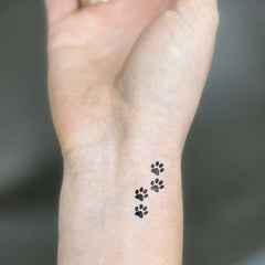 UBICA dog paw tiny illustration tattoo for playful style.