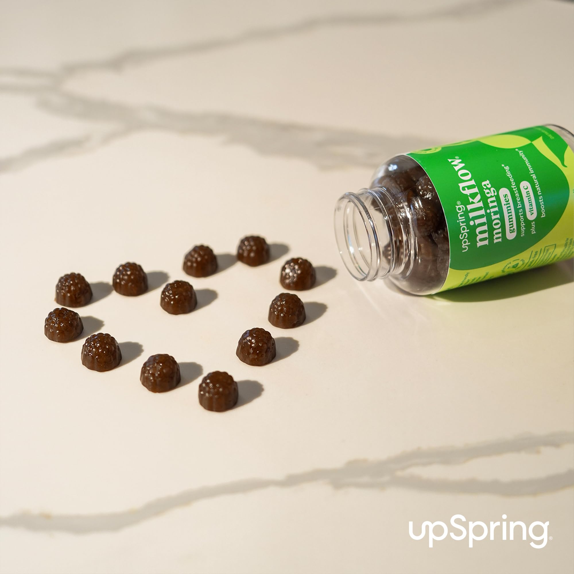 Gummies with moringa leaves and Vitamin C fruits beside