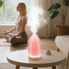 Close-up of the diffuser's glass-like body and wood grain base.