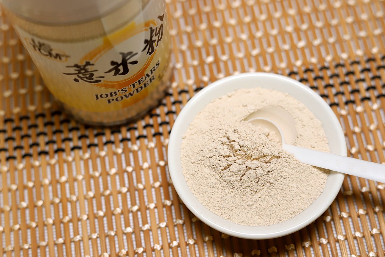Powder being poured into a cup for brewing