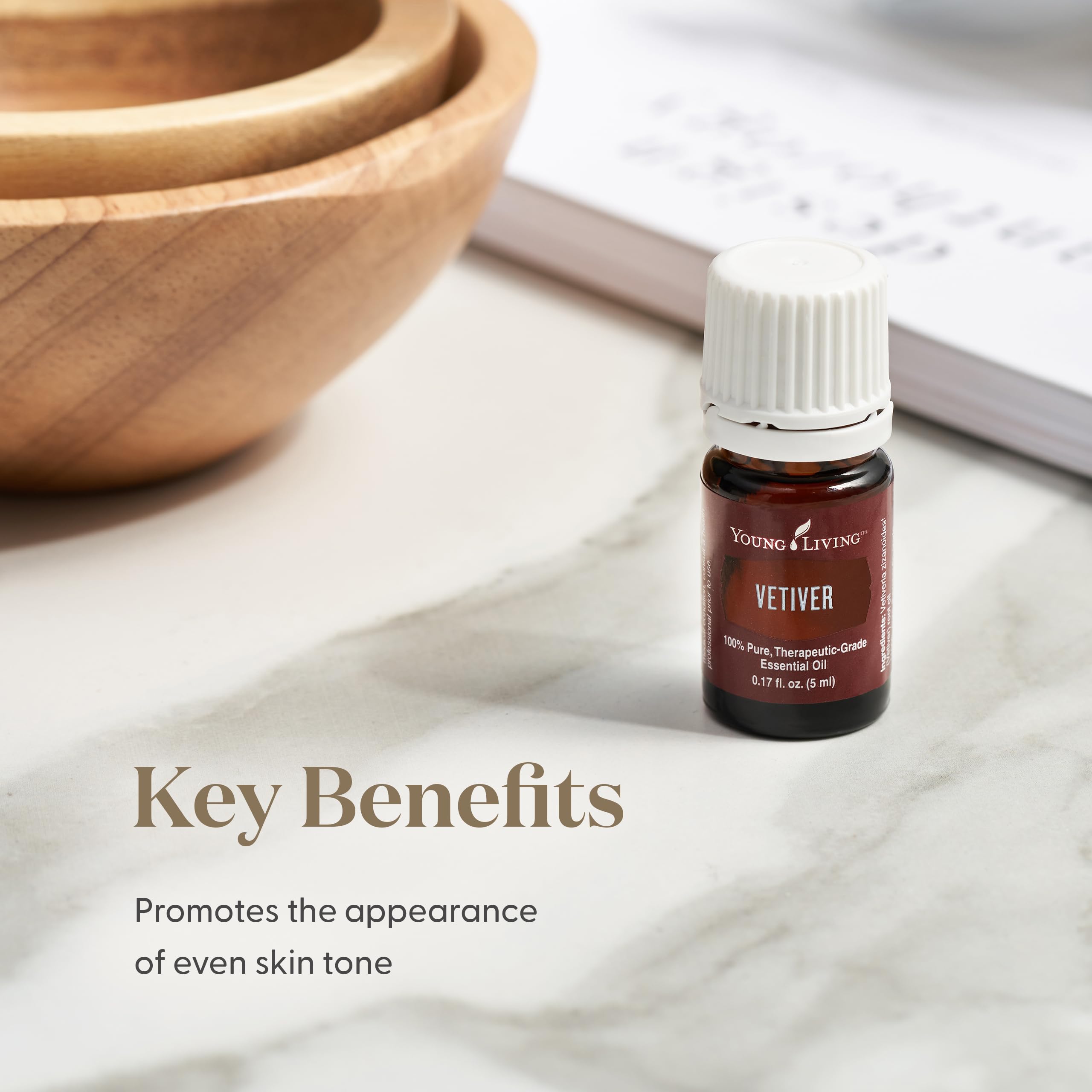 Vetiver oil wooden table diffuser setup suggests earthy, grounding home wellness ritual.