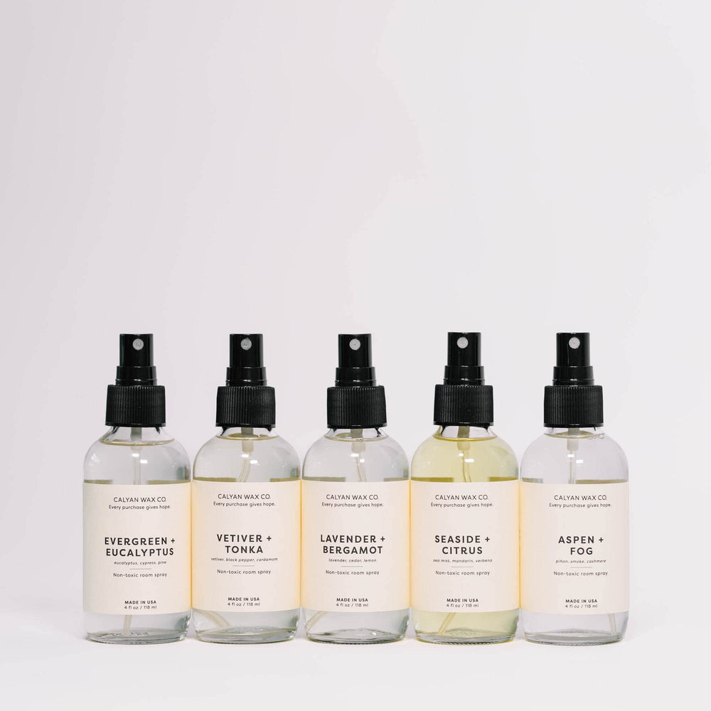 4 fl oz room spray bottle resting on a white surface