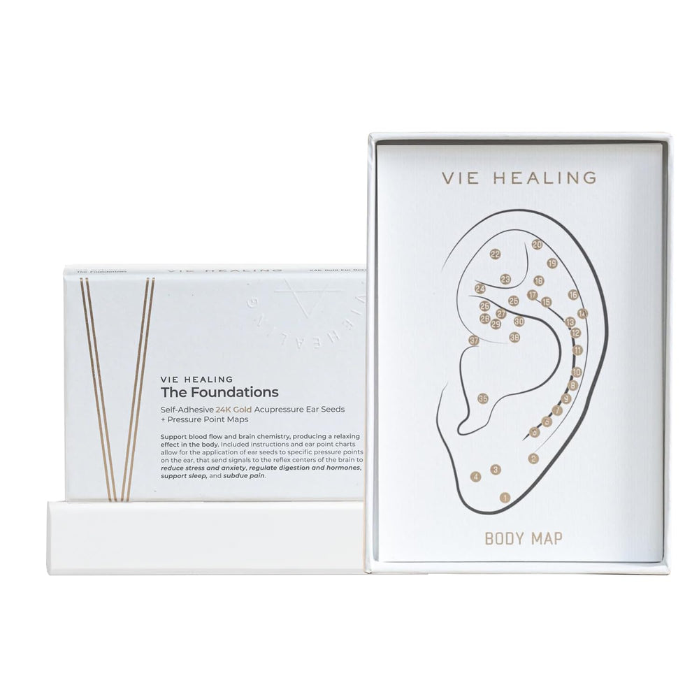 Vie Healing 24K gold ear seeds arranged on a white surface