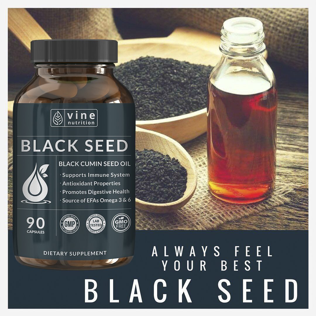 Several black seed oil capsules with natural background