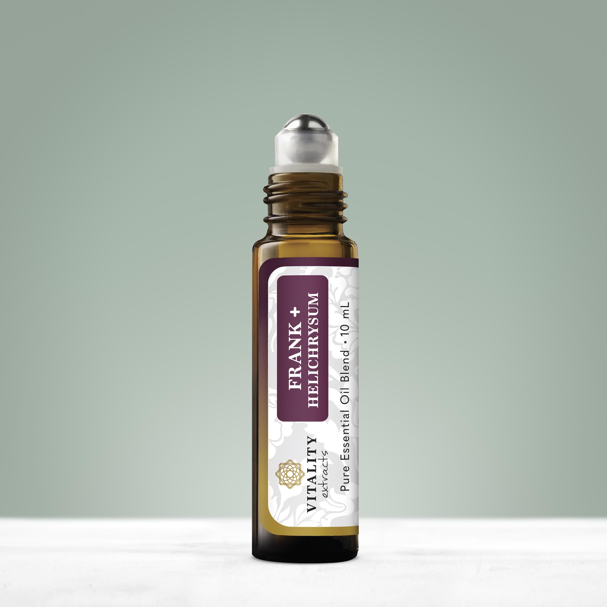 Close-up of Frank+ Helichrysum blend rollerball with bottle
