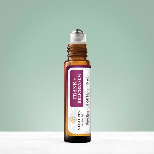 Close-up of Frank+ Helichrysum blend rollerball with bottle
