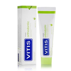 Minty foam and toothbrush alongside Vitis toothpaste 100ml