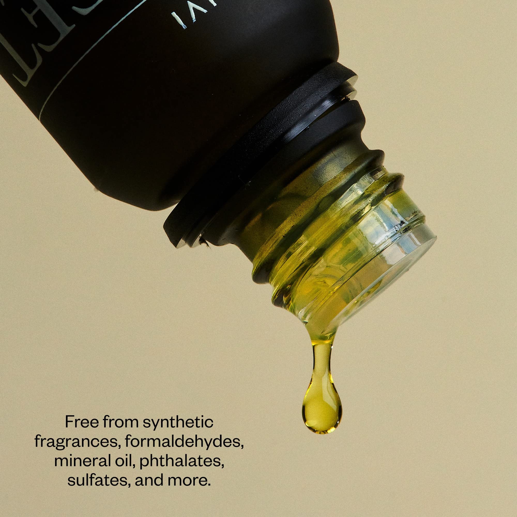 Drops of orange essential oil from a dropper