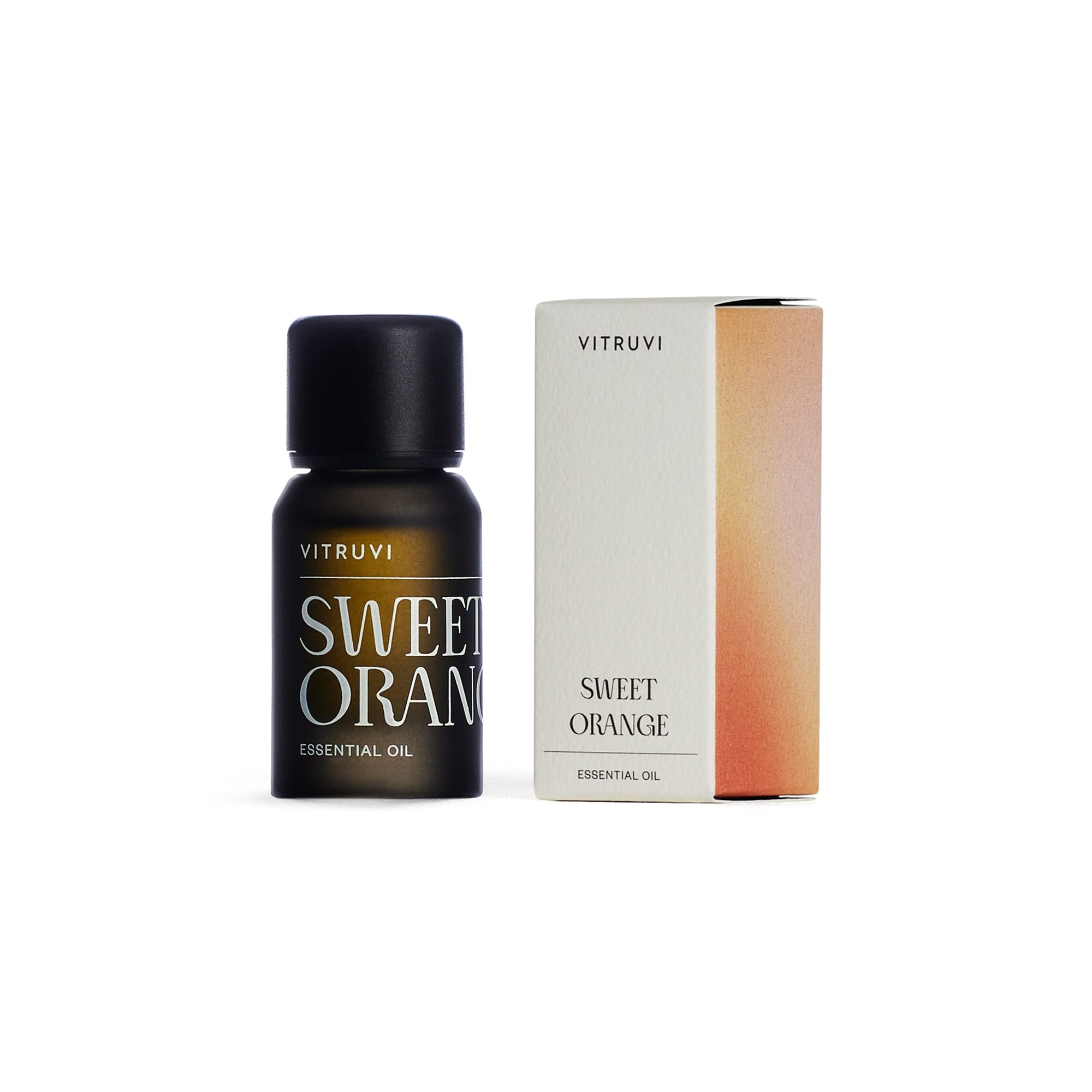 Lifestyle setup with Vitruvi orange essential oil bottle
