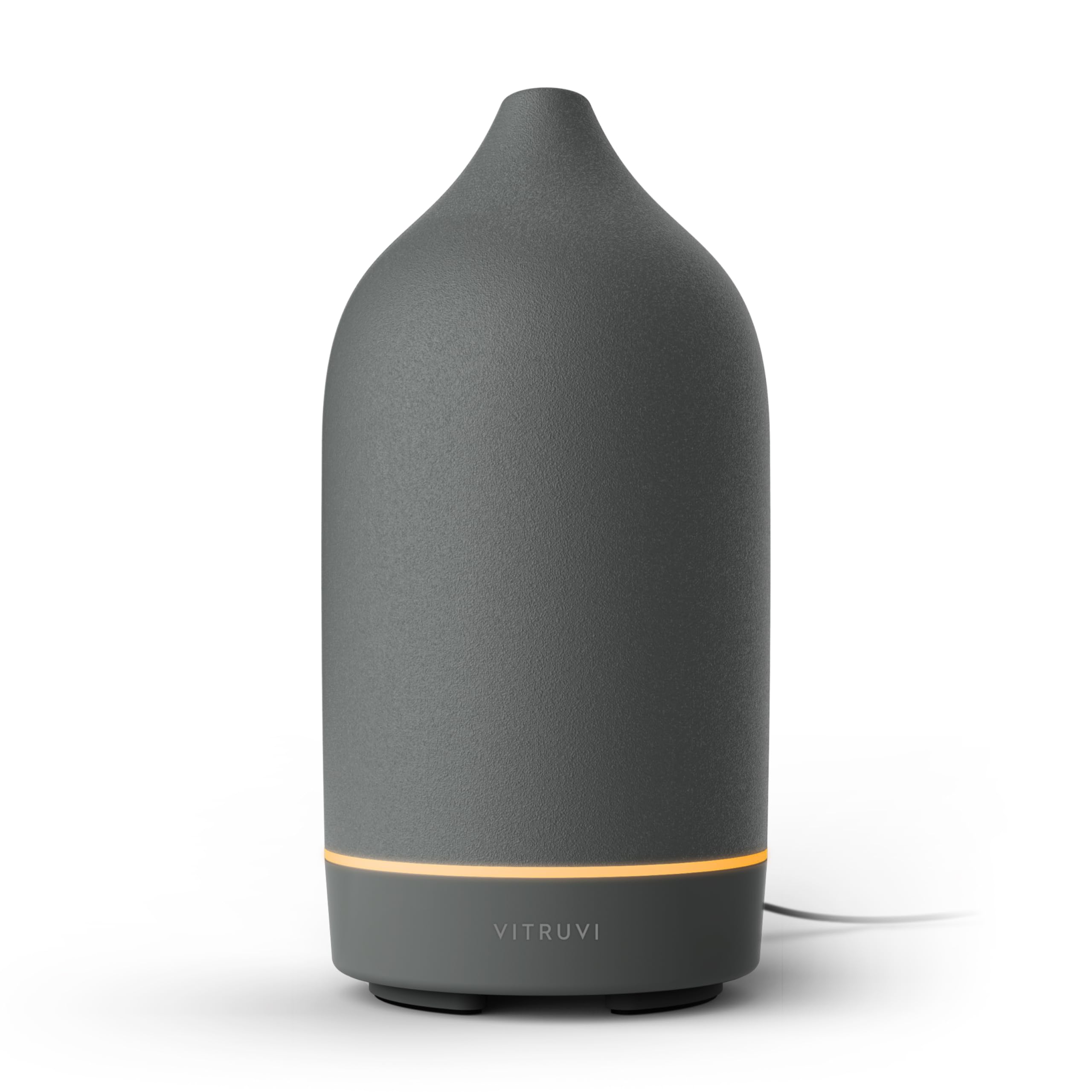 Vitruvi Stone Ceramic Ultrasonic Diffuser on a bedside table