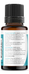 Close-up of peppermint essential oil in glass bottle