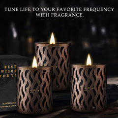 Warm amber scented candle in black jar