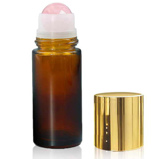 Warmify Rose Quartz Roller Bottle with amber glass cap for travel-ready essential oil use.