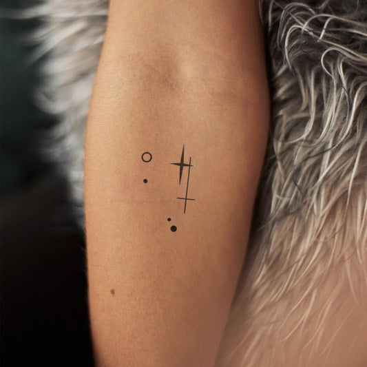 WEEKINK Libra glyph tattoo closeup with intricate lines.