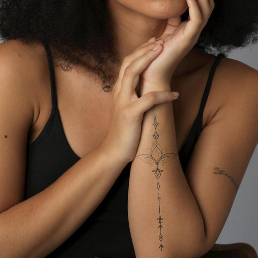 WEEKINK Lotus tattoo shown on arm arrangement for versatile placement.