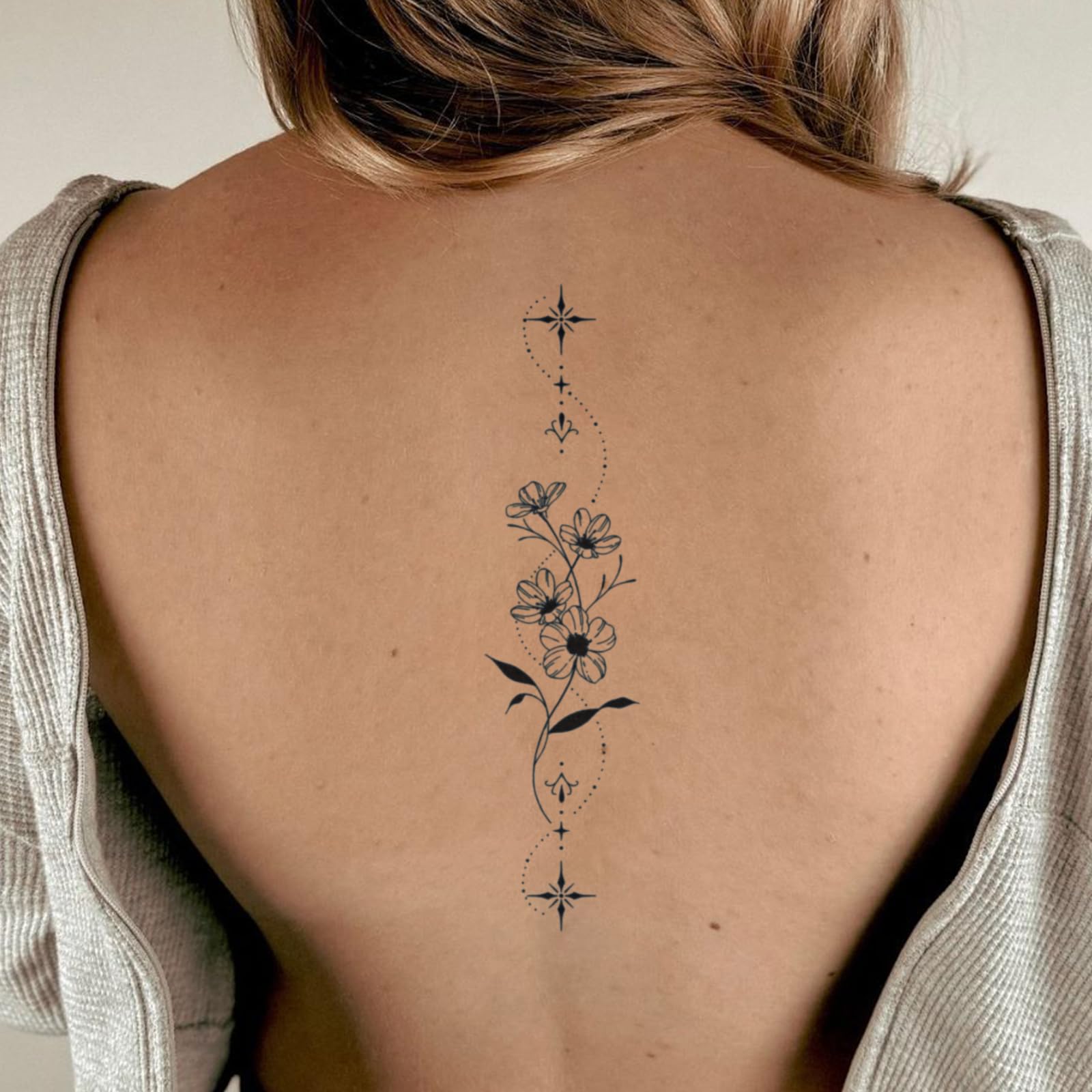 Weekink Spine Flower Tattoo delicate blossoms add feminine charm on skin.