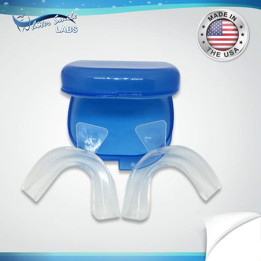 Upper and lower whitening trays fitted around teeth