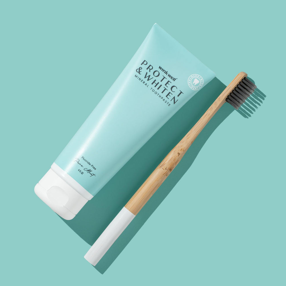 Toothpaste being dispensed onto a toothbrush