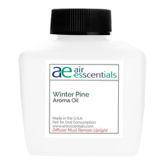Bottle of Winter Pine Aroma Oil 100mL with pine needles