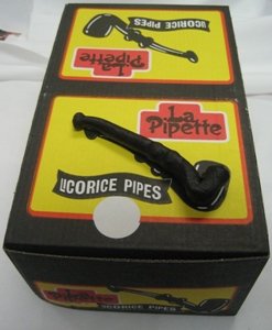 Close-up of black licorice pipes in display