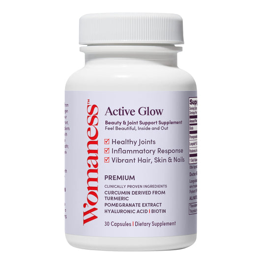 Womaness Active Glow bottle closeup highlighting biotin and hyaluronic acid for skin and hair support.