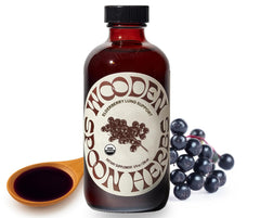 Wooden Spoon Herbs Elderberry Syrup bottle with 8 oz label on a wooden surface