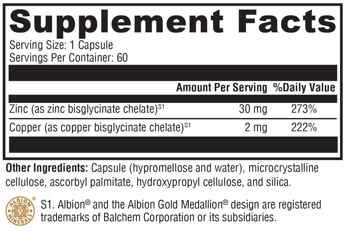 Close-up of Zinc+Copper supplement capsules in XYMOGEN bottle