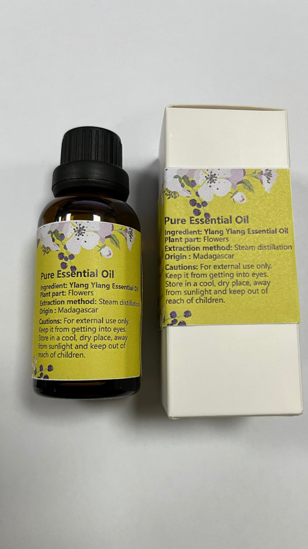 Close-up of Ylang Ylang oil bottle with dropper