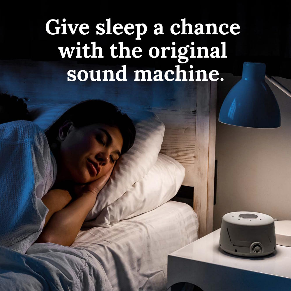Yogasleep Dohm Classic Gray on nightstand, travel-friendly design for hotel sleep