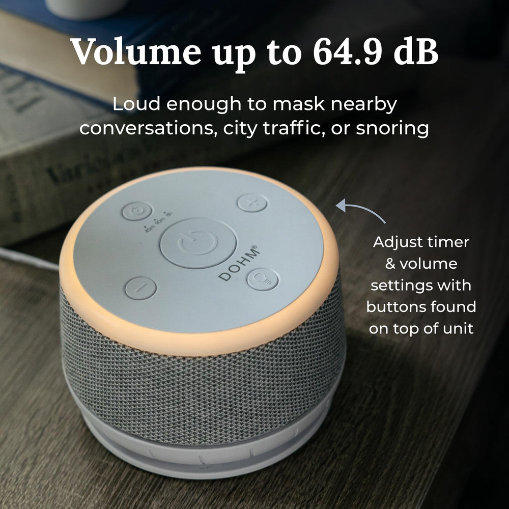 Yogasleep Dohm Nova night light glows softly for gentle bedtime ambiance.